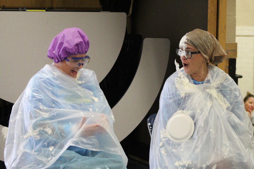 Welchester Elementary School Assistant Principal Jennine Tarpley and Principal Bethany Robinson are hit with a serving of whipped cream during a Dec. 2 assembly. The two students and teacher who sold the most pastries during a recent fundraiser won the honor of "pieing" Tarpley and Principal Bethany Robinson.